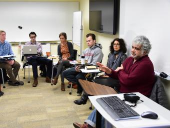 Arab studies class arranges desk in a circle while listening to a discussion led by Khaled Khalifa, a Syrian screenwriter and novelist