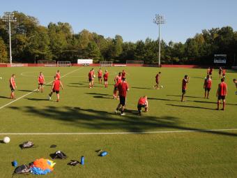 Alumni Soccer Stadium field during a soccer team practice where team members are scattered across the field