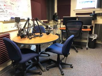 Podcast Studio room with tables, microphones and computers 