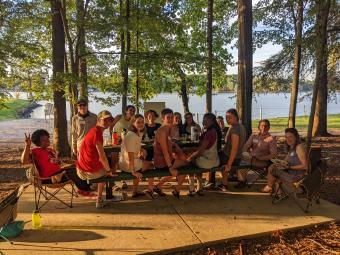 Outdoor Odyssey students eating dinner with President Doug Hicks
