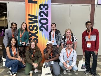 Group of students standing in front of a sign that says "SXSW"